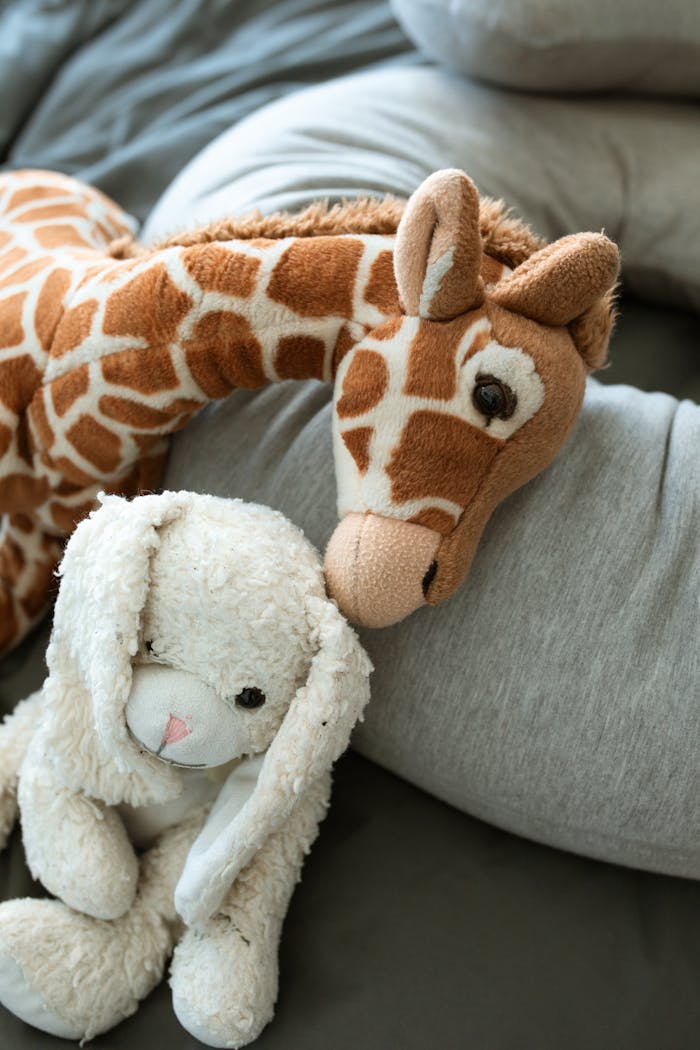 The Art of Drawing Readers In: Your attractive post title goes here Soft giraffe and bunny toys on a cozy blanket, perfect for childhood comfort.