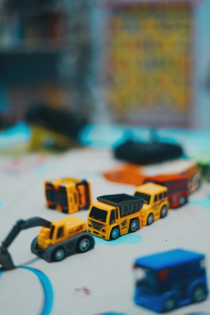 A collection of toy construction trucks on a play mat, showcasing vibrant colors and details.
